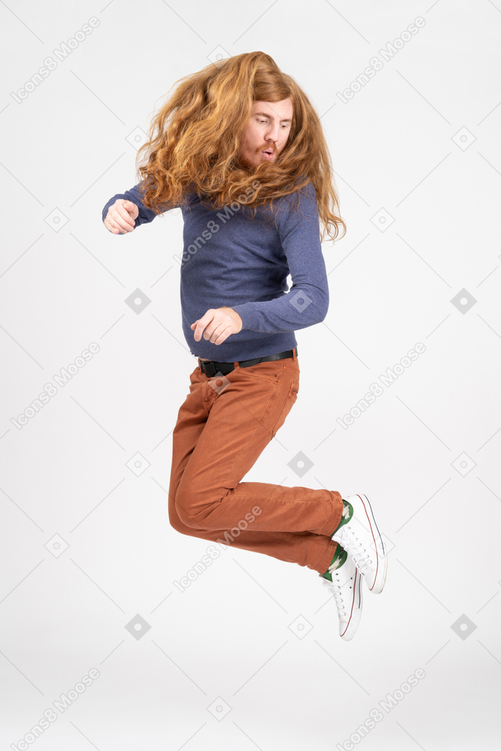 Young man in casual clothes jumps