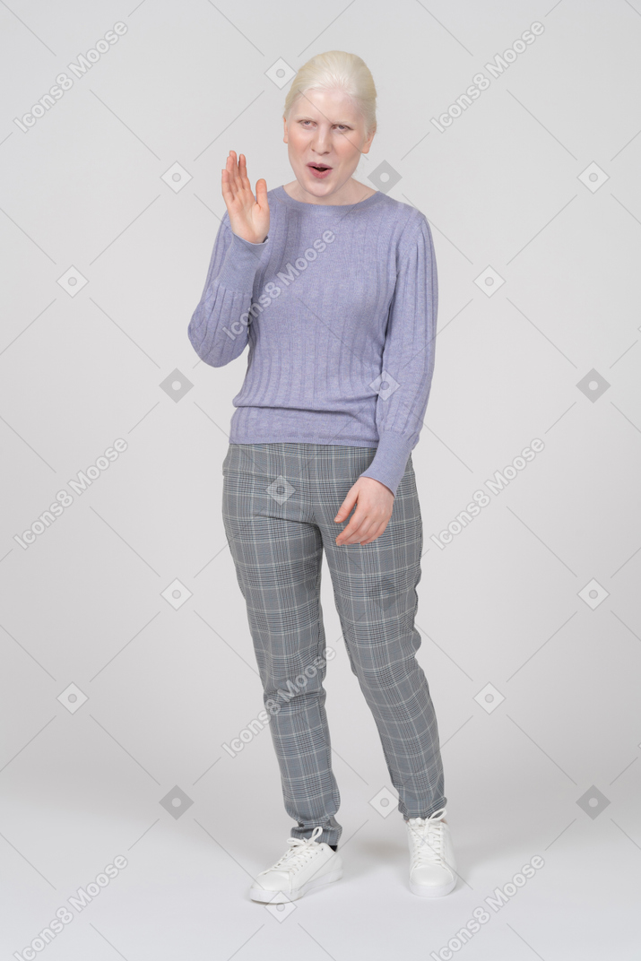 Excited young woman waving her hand