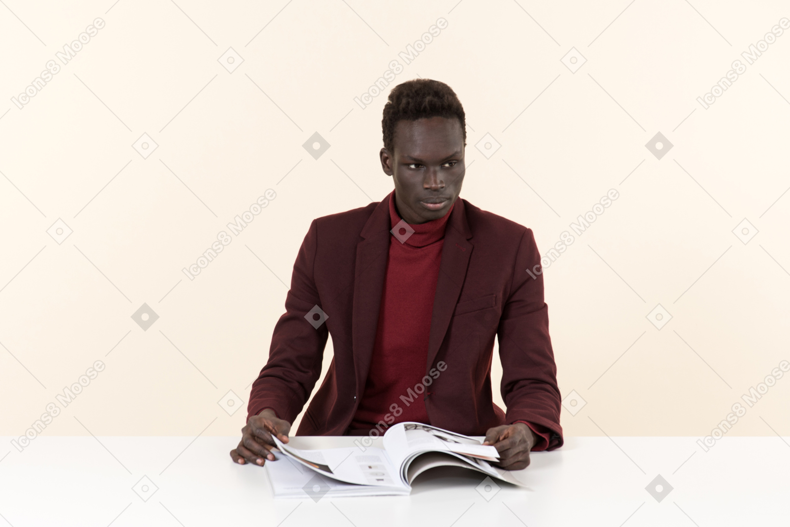 Elegant black man sitting at the table in the office