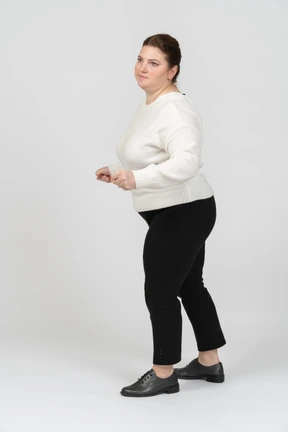Plump woman in casual clothes dancing