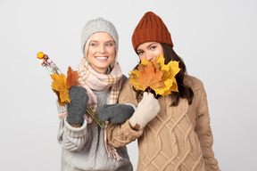 Gathering colorful maple leaves with a friend