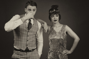 Young man standing with his girlfriend and drinking a shooter