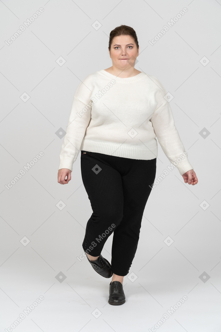 Plump woman in casual clothes biting her lip