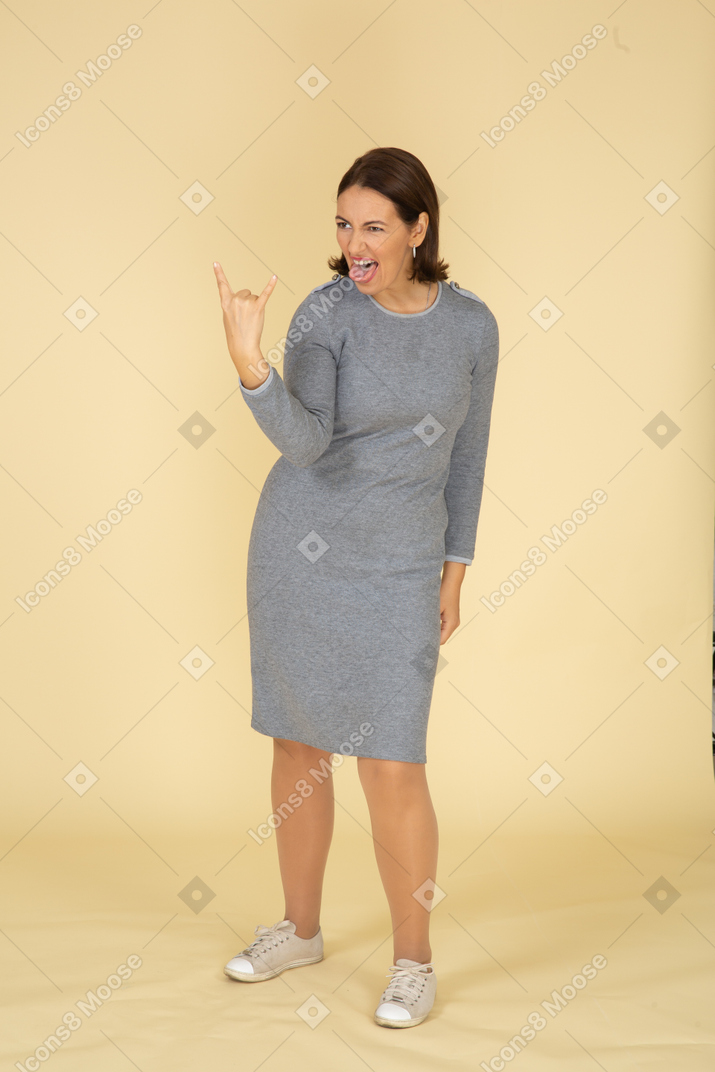 Side view of a woman in grey dress gesturing