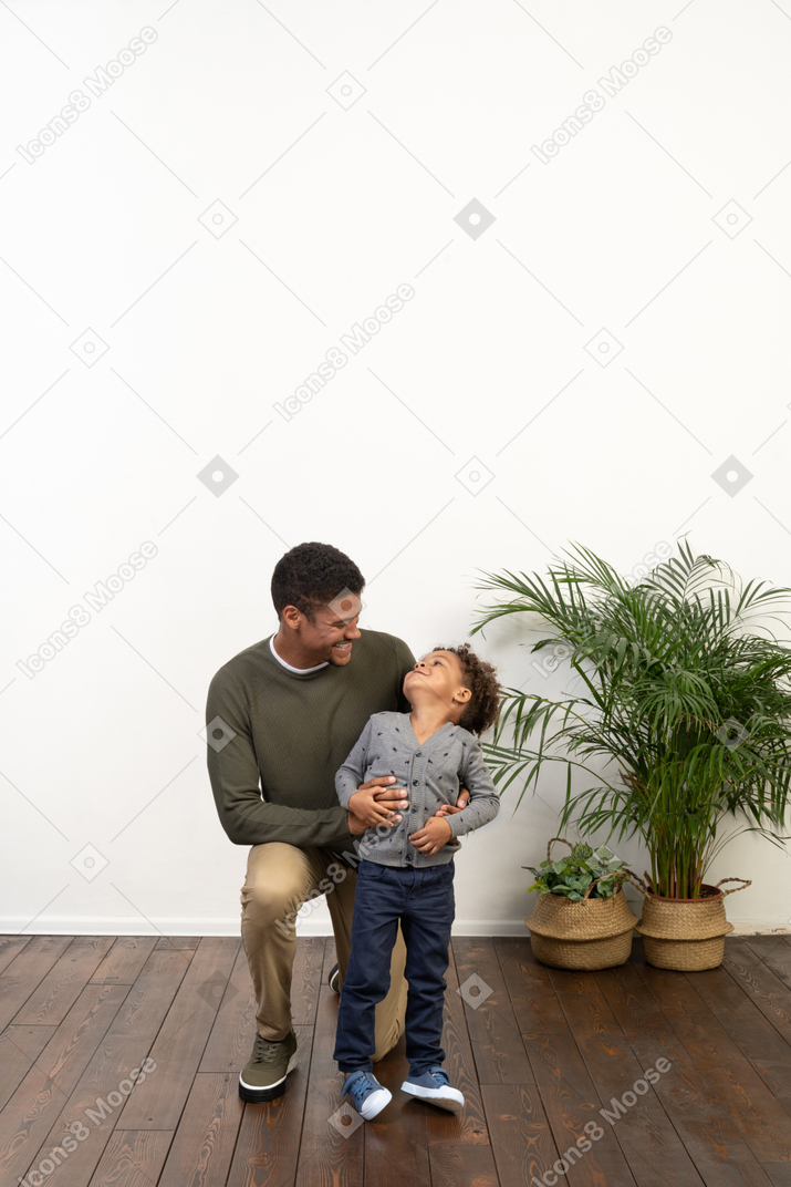Good looking young man on knees with a boy