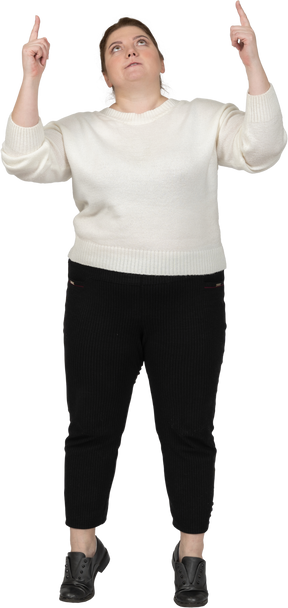 Front view of a plump woman in casual clothes pointing up