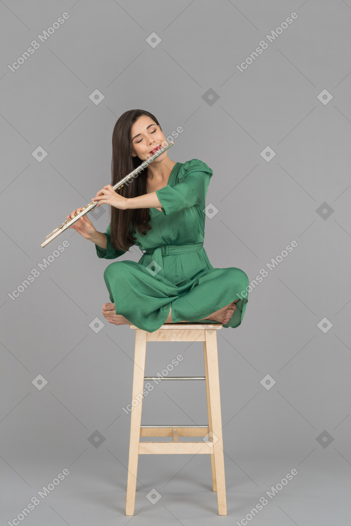 A beautiful young woman playing a flute