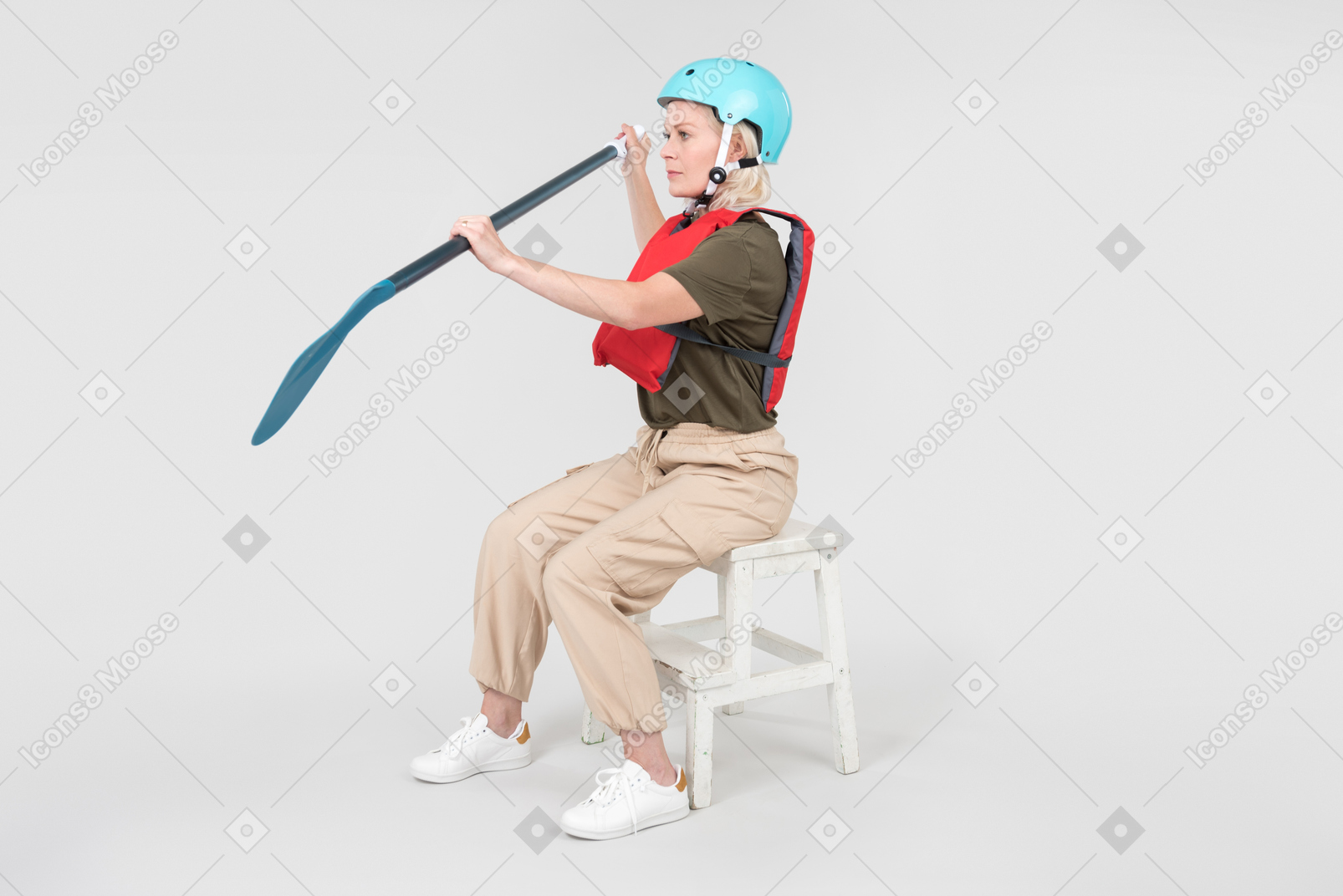 Mature woman in helmet sitting and learning how to paddle