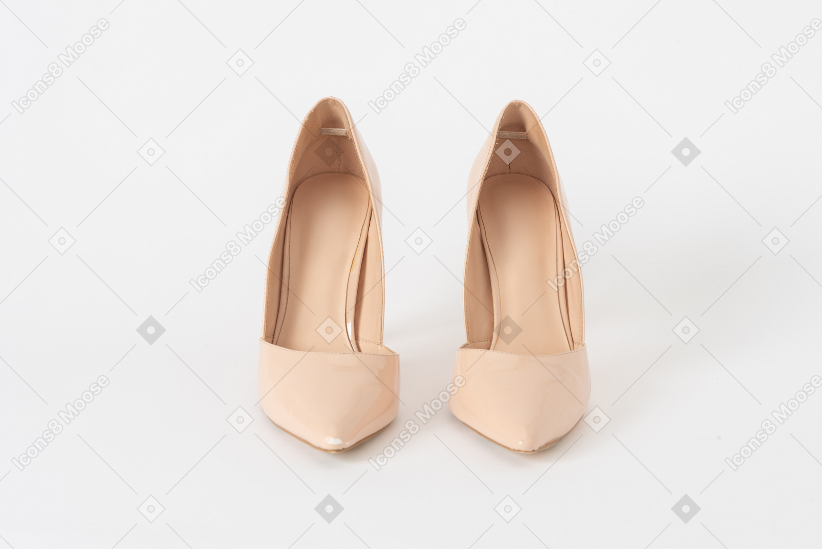 A front shot of a pair of beige lacquered stiletto shoes