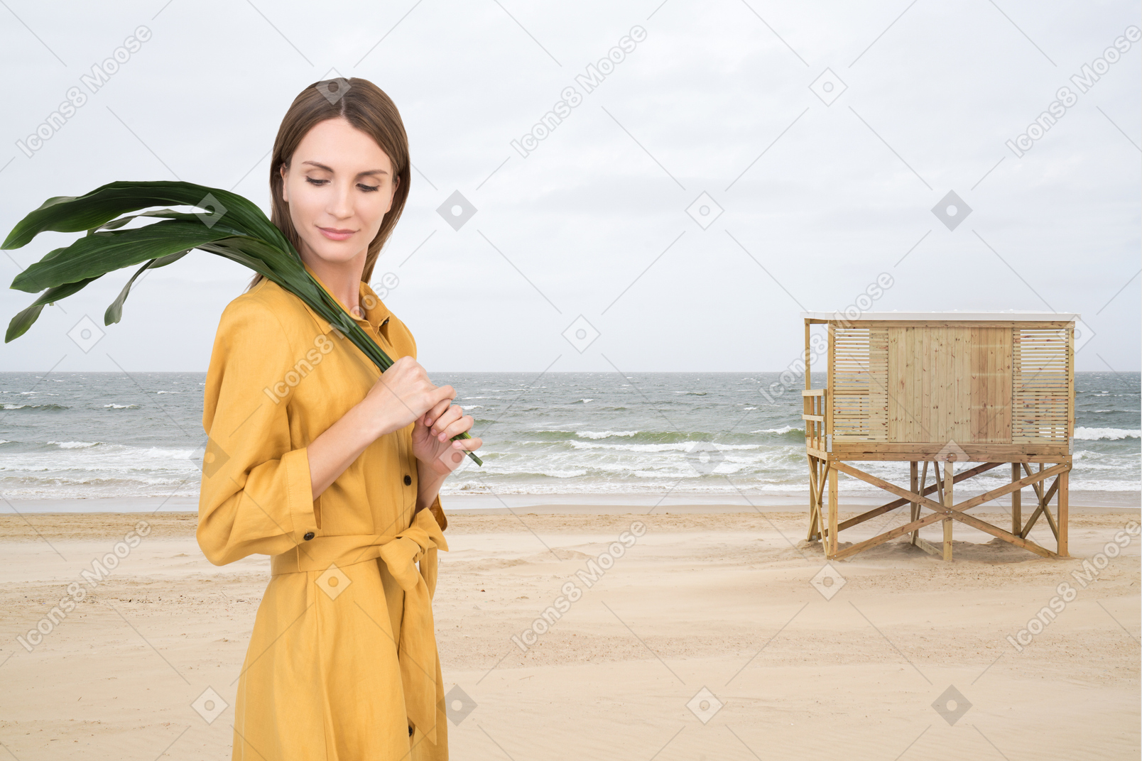 Mulher com folhas verdes caminhando na praia