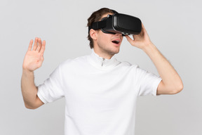 Impressed man wearing virtual reality headset