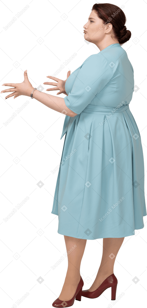 Side view of a woman in blue dress gesturing