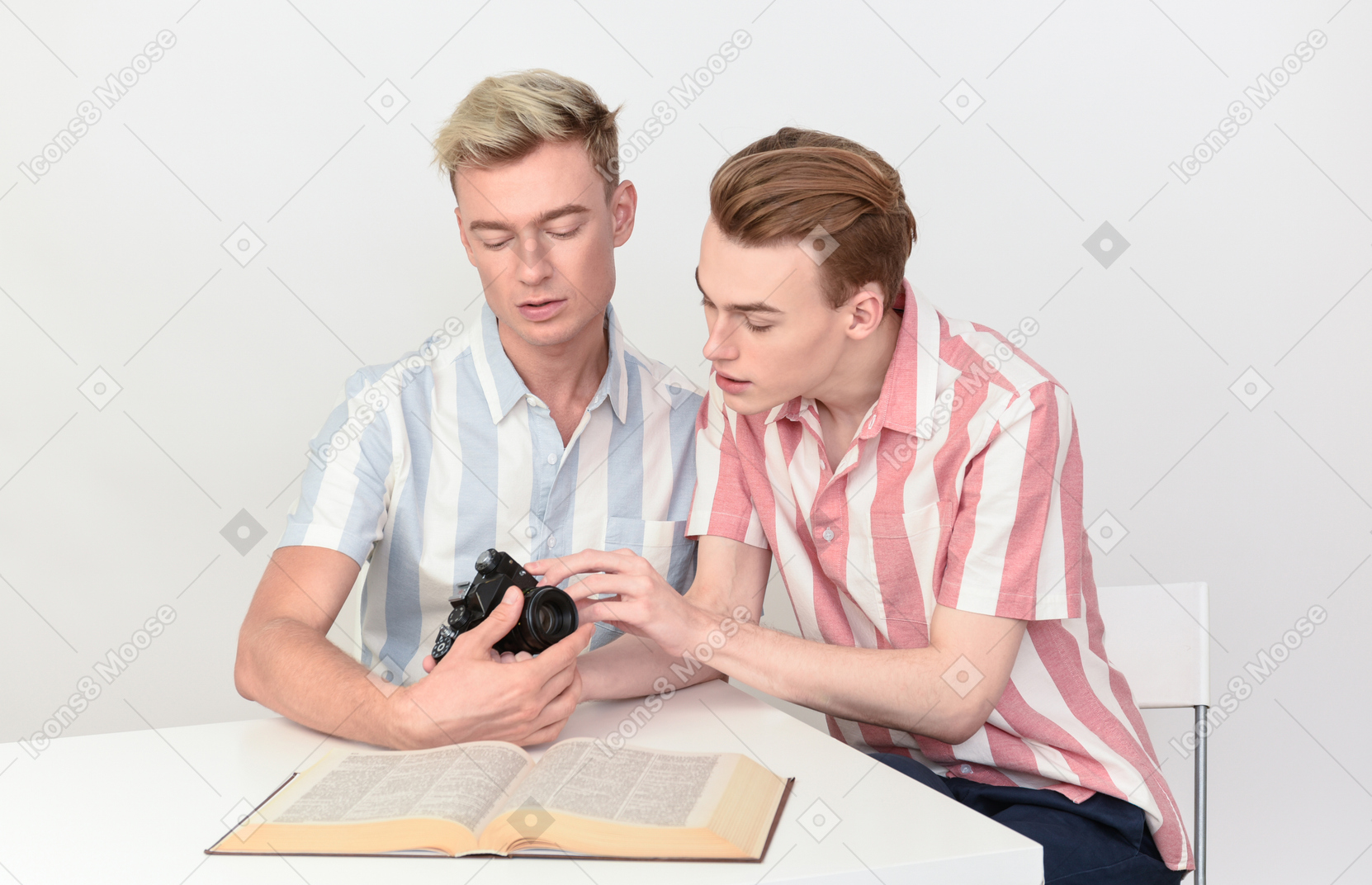 Gay couple focused on figuring out how to use camera