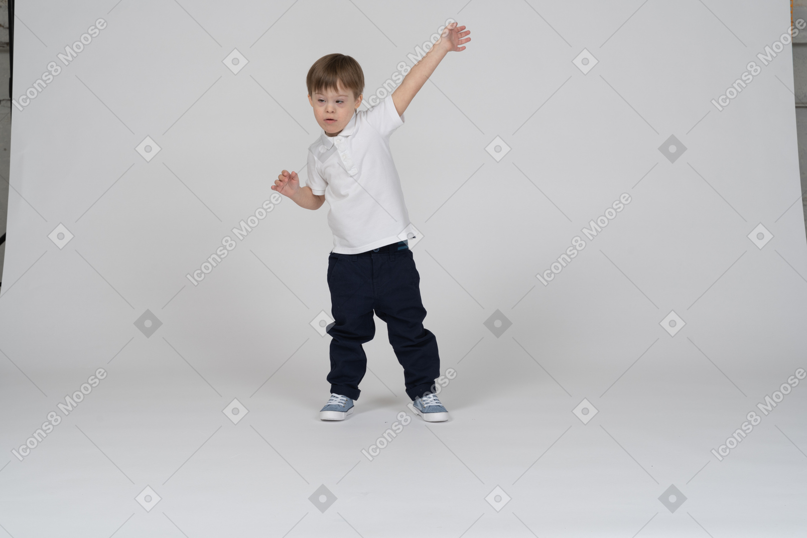Front view of a little boy raising his arm