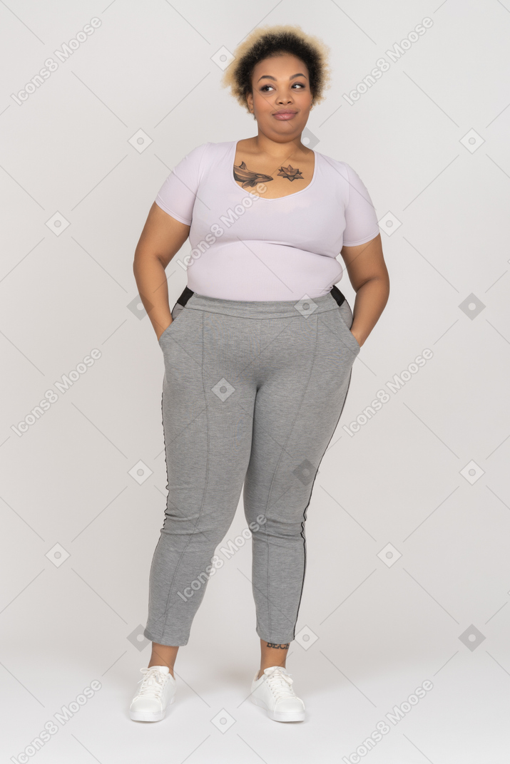 Skeptic plump afro female holding hands in pockets