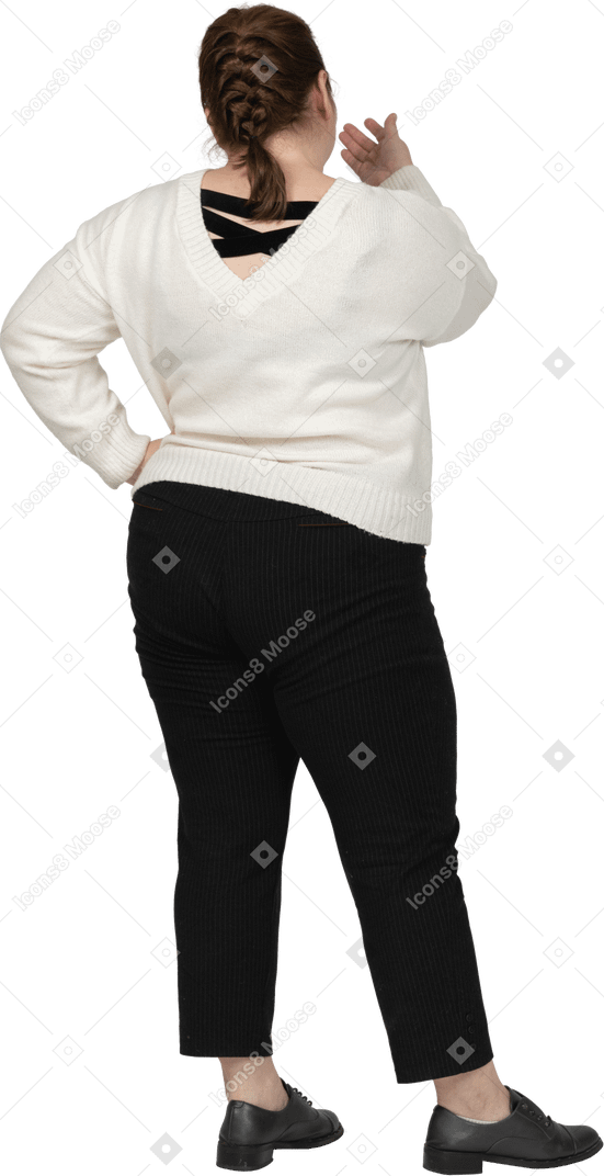 Rear view of a plump woman in casual clothes posing