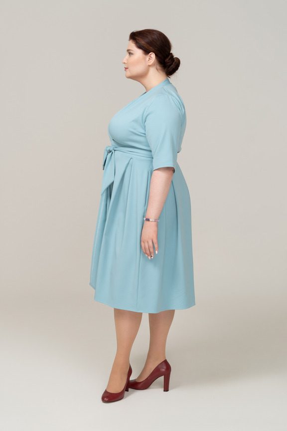 Side view of a happy woman in blue dress Photo
