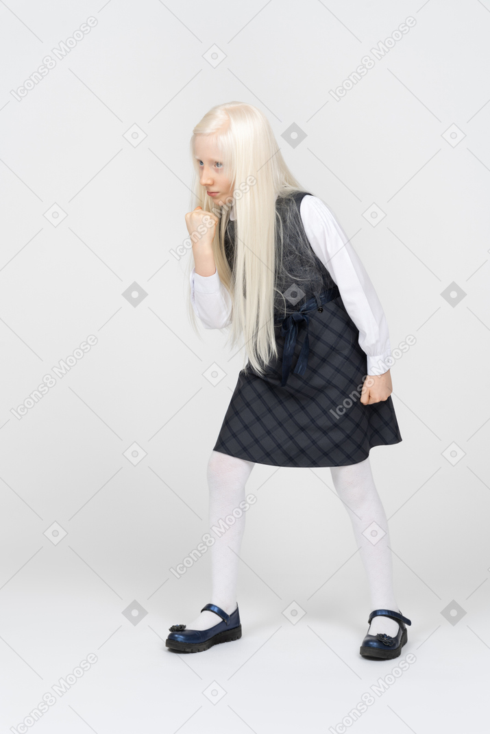 Schoolgirl clenching her fist, ready to fight