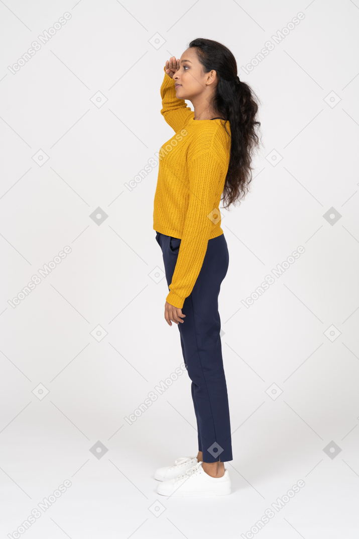 Side view of a girl in casual clothes saluting with hand