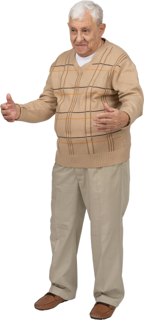 Front view of an old man in casual clothes standing with outstretched arms