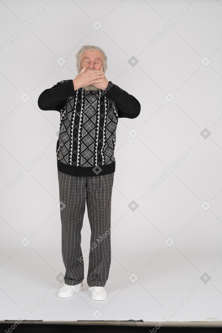 Old man with eyes closed covering mouth