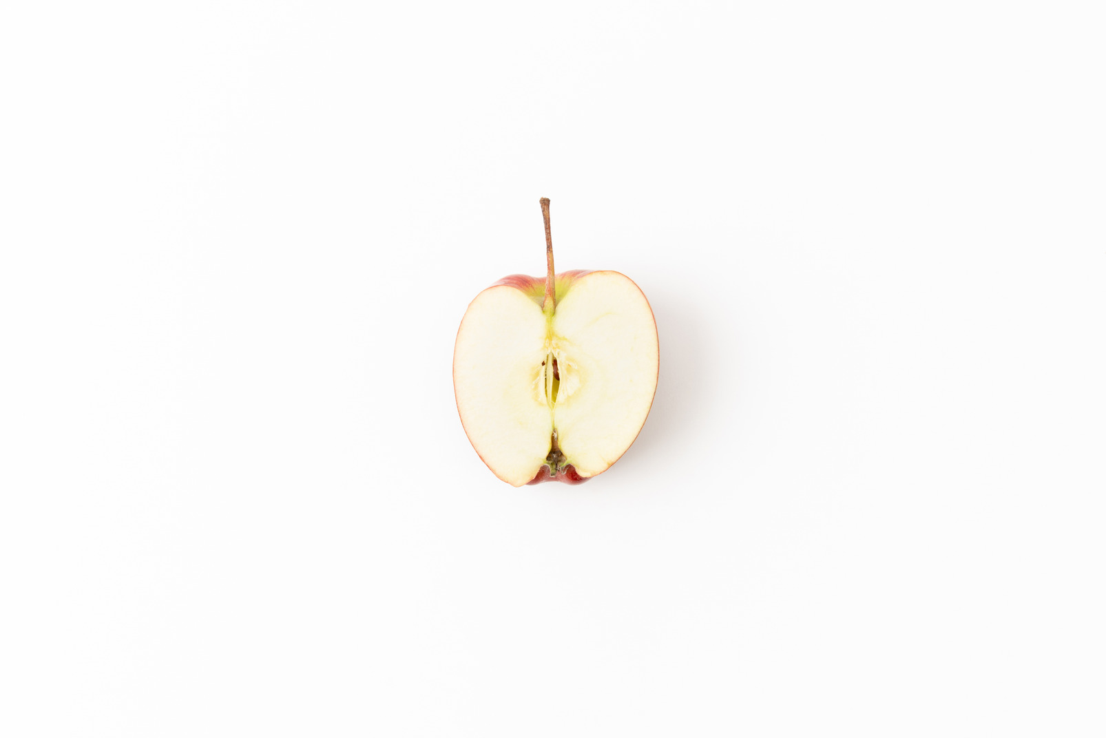 Half of red apple on white background