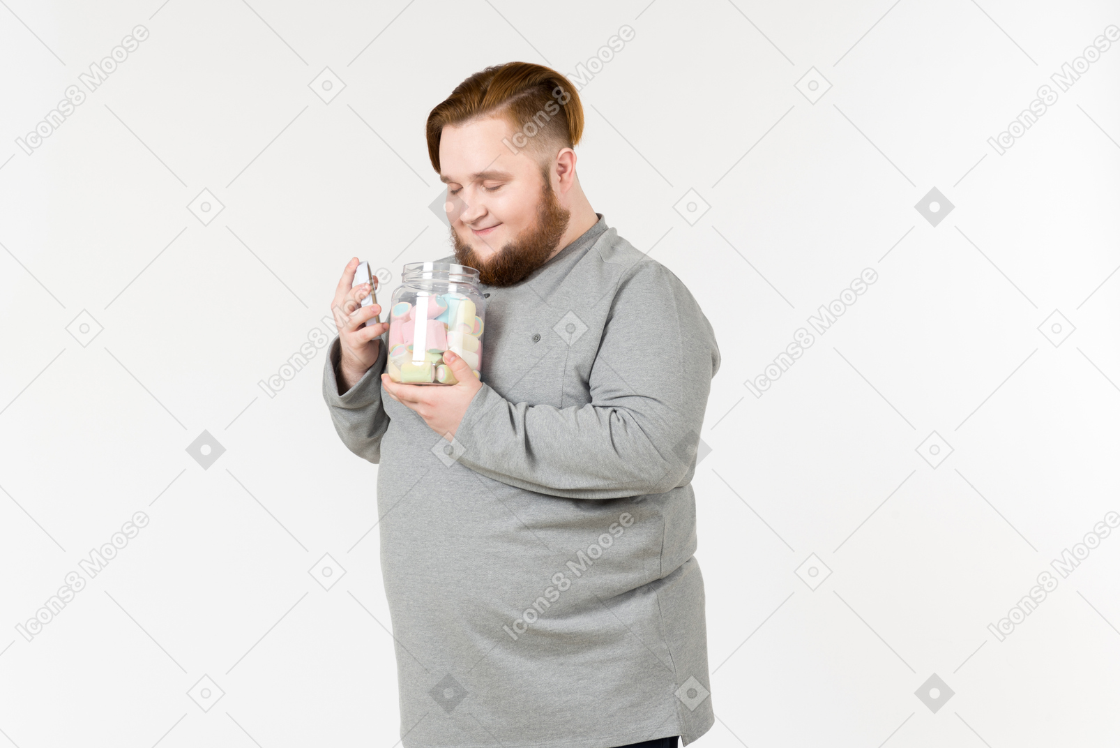 Big bearded man holding jar of marshmallows