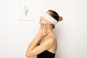 Woman with bandage over eyes tilting head back