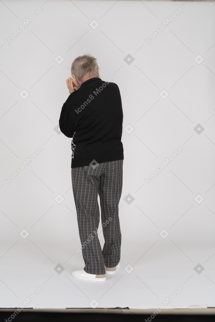 Rear view of old man folded hands like sleeping