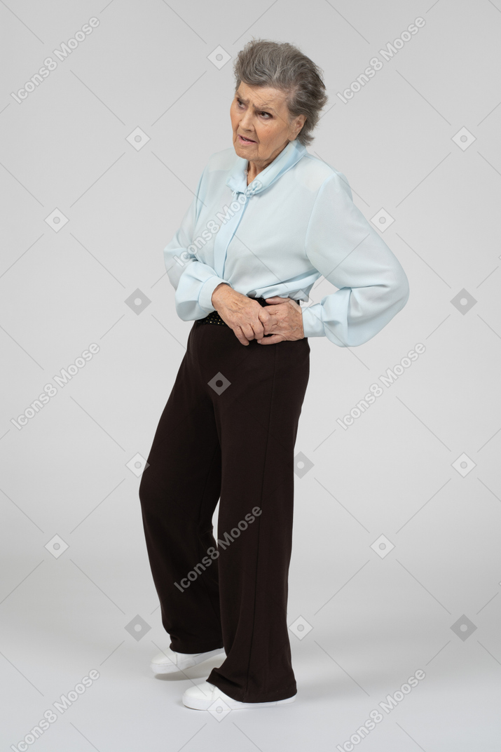 Old woman standing and looking suspiciously