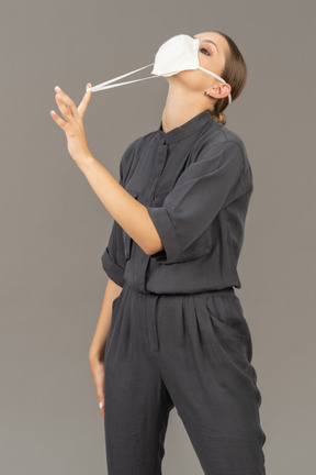 Woman pulling on the strings of the respirator