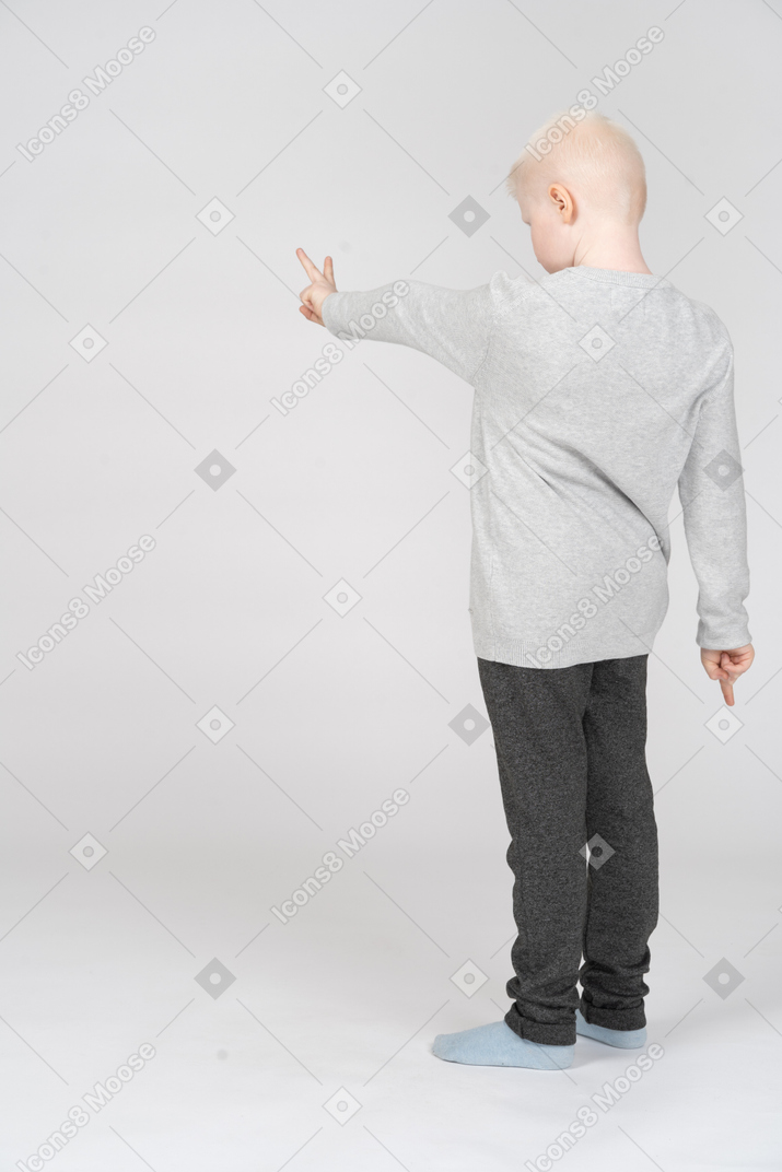 Boy making a peace sign