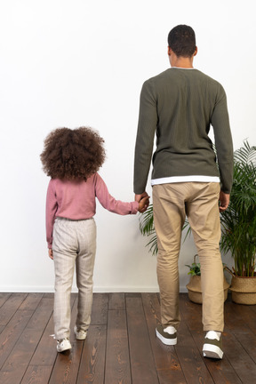 Father and daughter hold hands