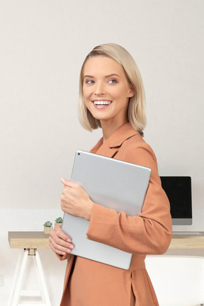 A woman holding a tablet in office