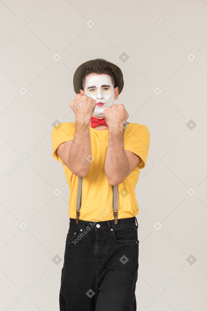 Male clown holding his fists up