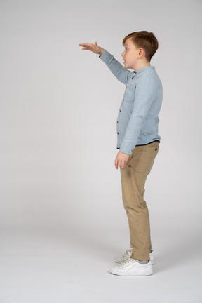 Young boy lifting up his hand