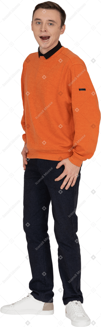 Young man in orange sweatshirt standing