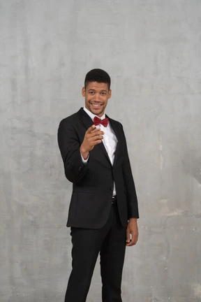 Man in black suit pointing