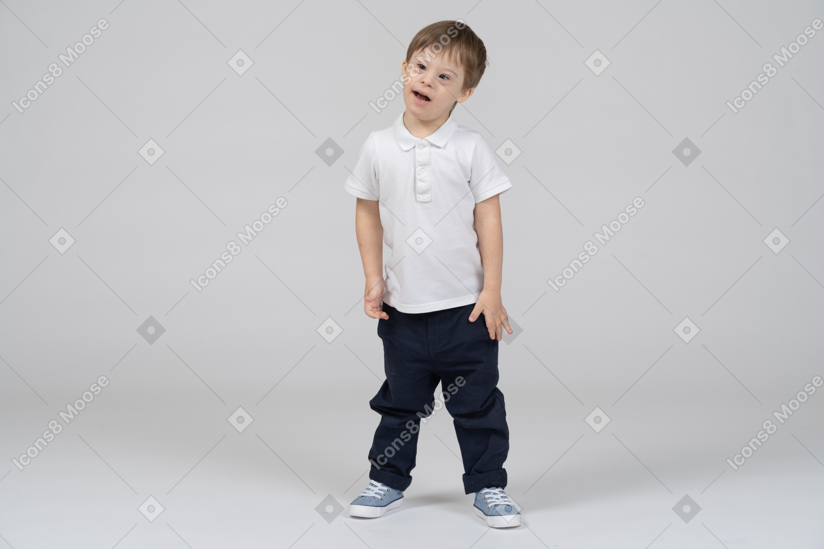 Confused little boy standing with arms at sides