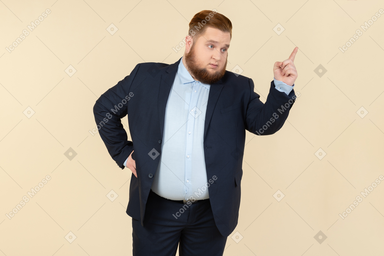 Severe looking young overweight man in suit pointing up