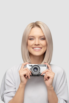 Young woman holding vintage camera