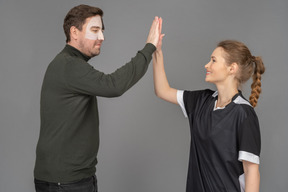 Male fan giving a female football player a high five