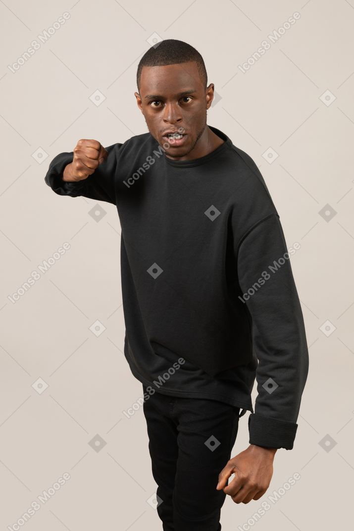 Angry young man throwing a punch