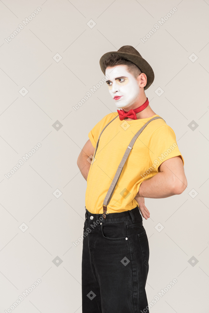 Male clown standing with hands on his hips