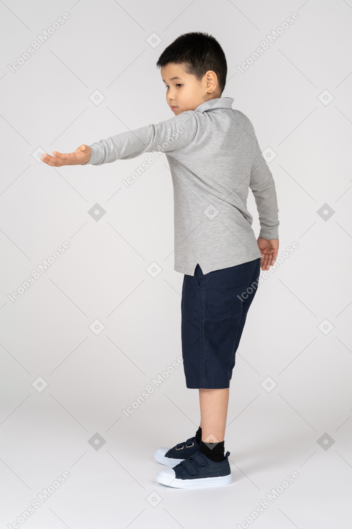 Boy stretching his hand forward