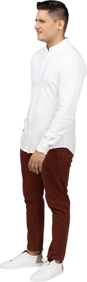 Three-quarter view of a young latino man frowning slightly in distaste