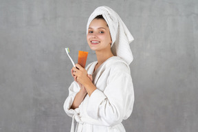 Smiling young woman ready to brush her teeth