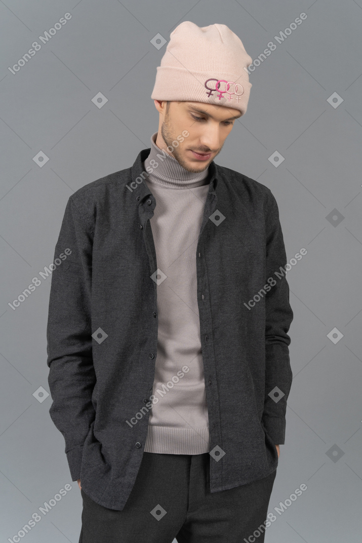 Thoughtful man in pink hat standing still