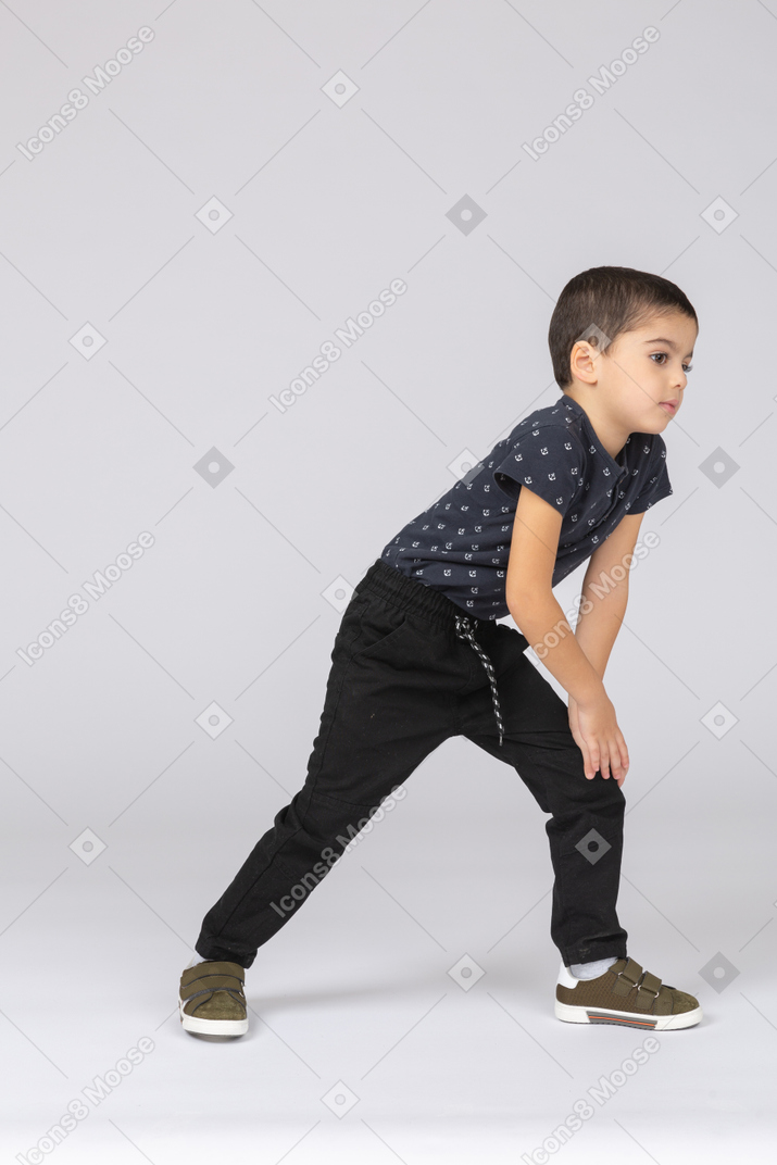 Front view of a cute boy making a lunge