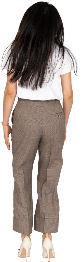 Back view of a jumping young lady in breeches and t-shirt